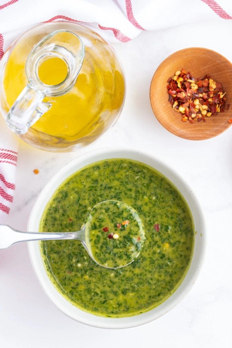 bowl of chimichurri sauce with spoon inside