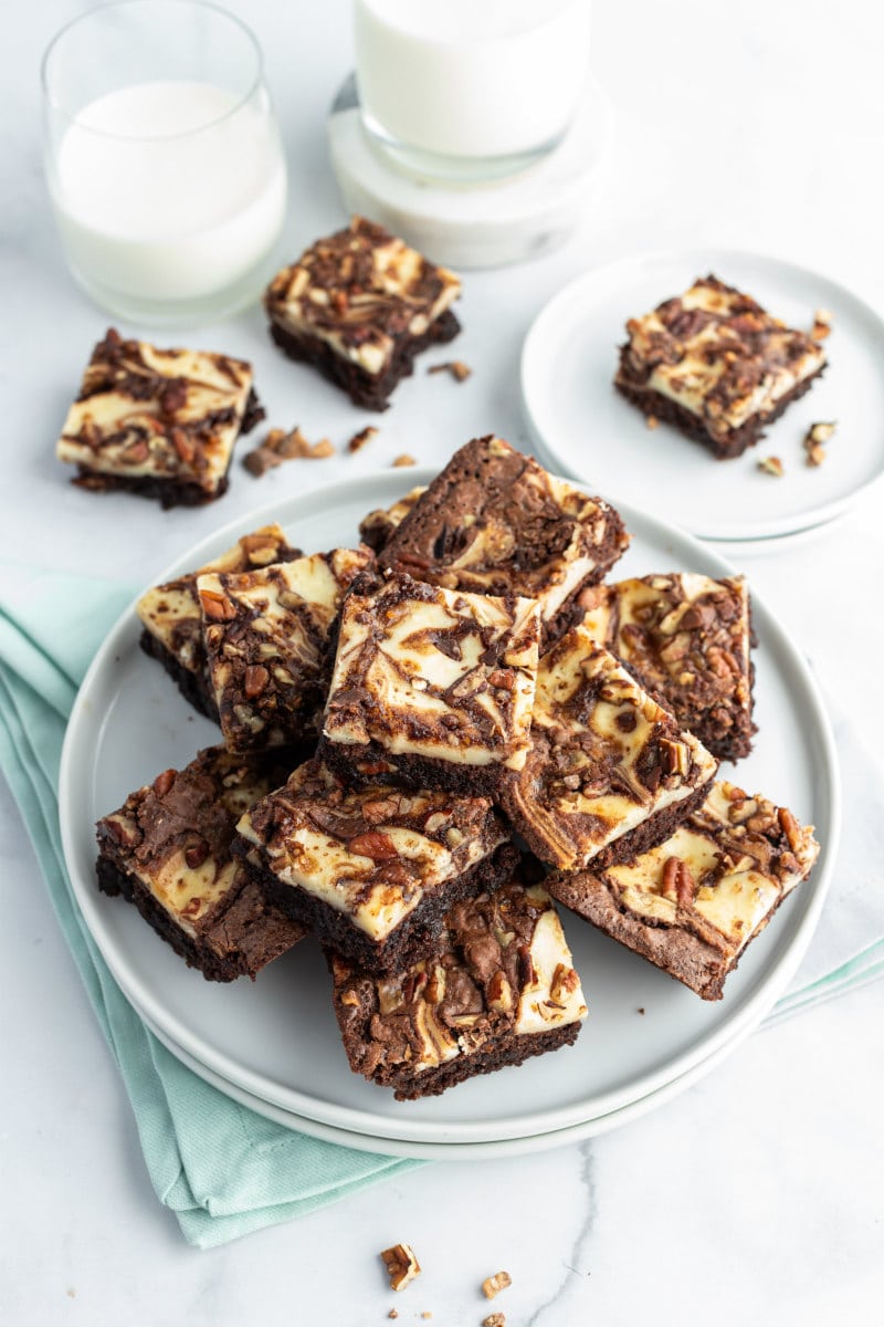 white plate with cream cheese swirl brownies on top