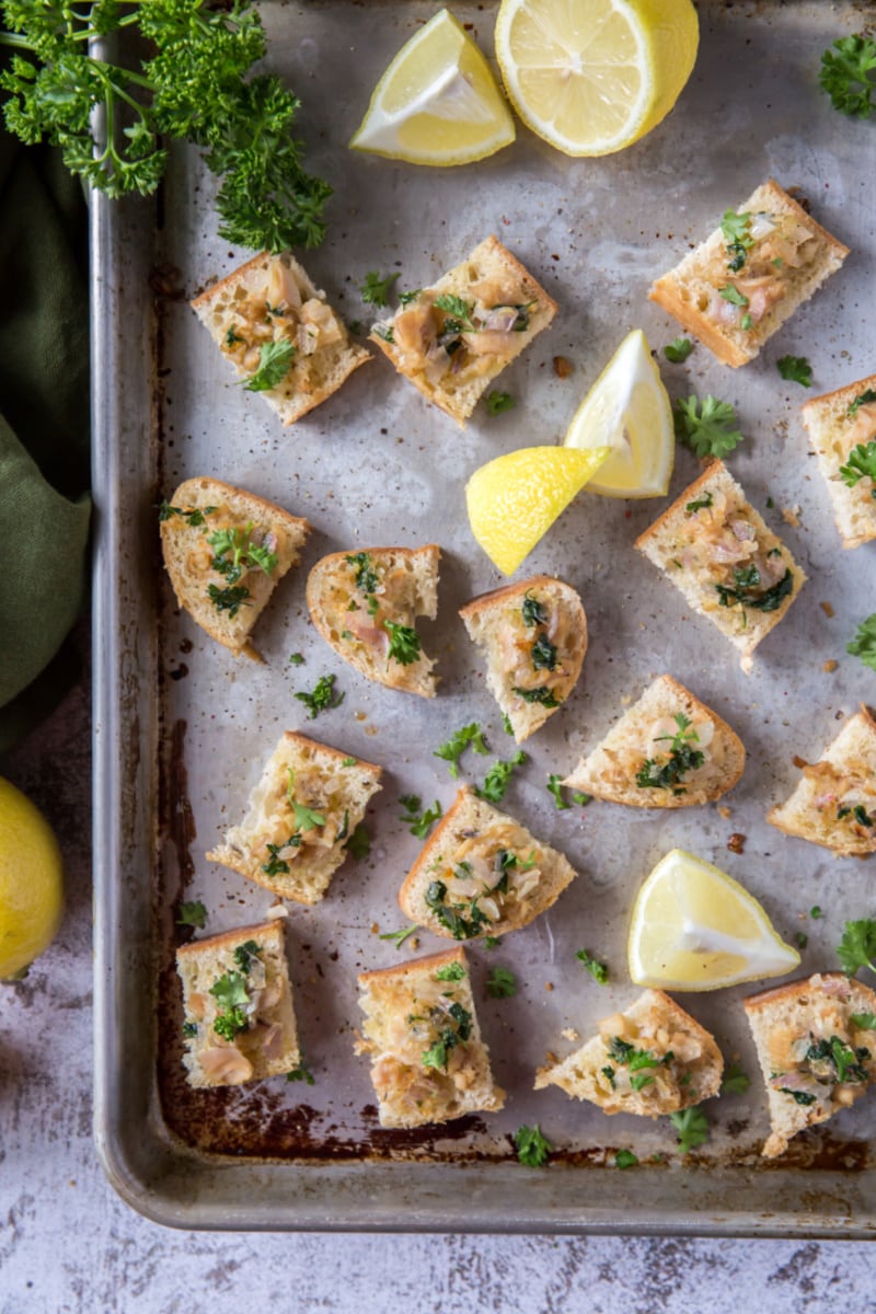 crostini with clams on a baking sheet