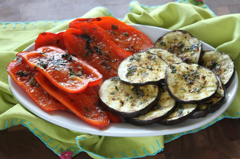 Grilled Aubergine and Peppers recipe from RecipeGirl.com #grilled #grilling #aubergine #eggplant #peppers #red #redpepper #bell #redbellpeppers #summer #vegetables #recipe #RecipeGirl Platter of Grilled Aubergine and Peppers