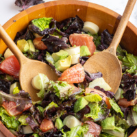 wooden bowl with servers in hearts of palm avocado salad