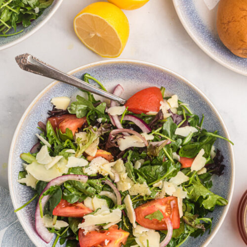 mixed green salad with honey lemon dressing in bowl