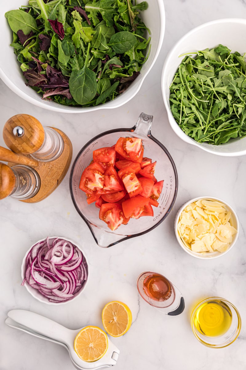 ingredients displayed for making mixed green salad with honey lemon dressing