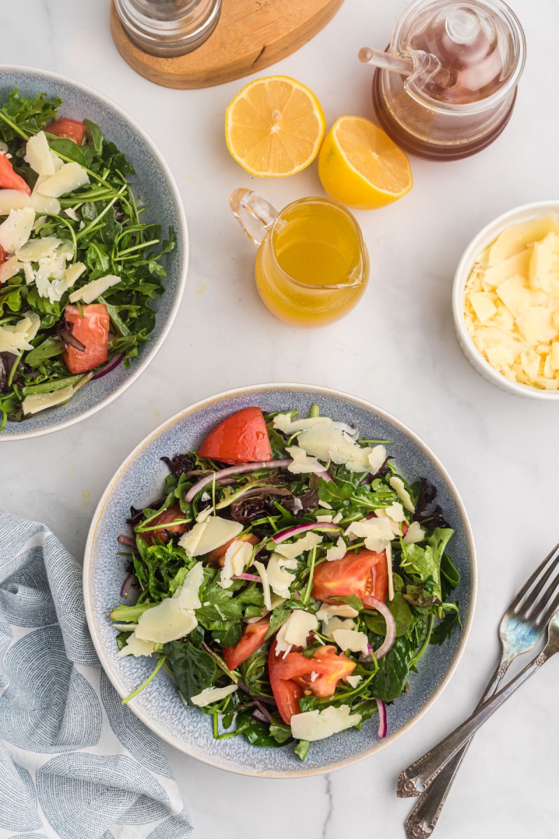 mixed green salad with honey lemon dressing in two bowls