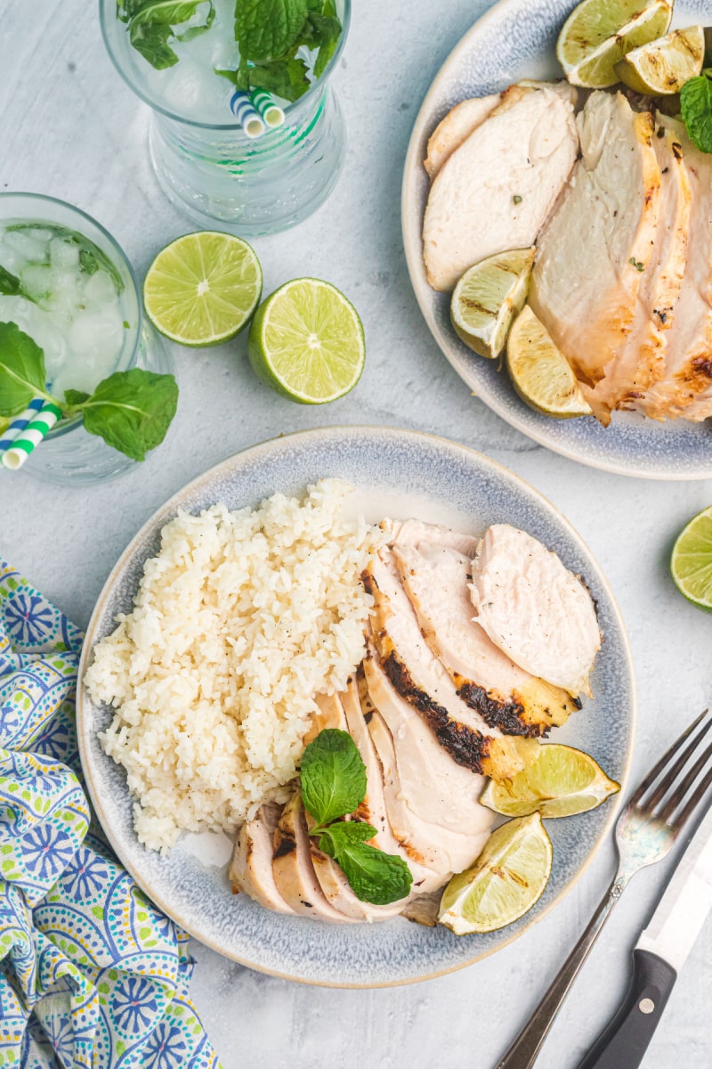 mojito marinated chicken breast sliced on plates with rice
