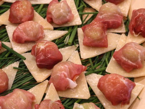 Prosciutto Purses Prosciutto Purses Appetizers displayed on bed of chives