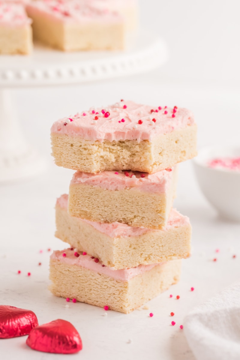 stack of four sugar cookie bars with bite taken out of top one