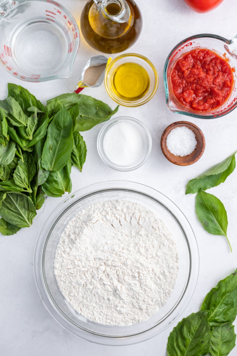 ingredients displayed to make tomato basil bread