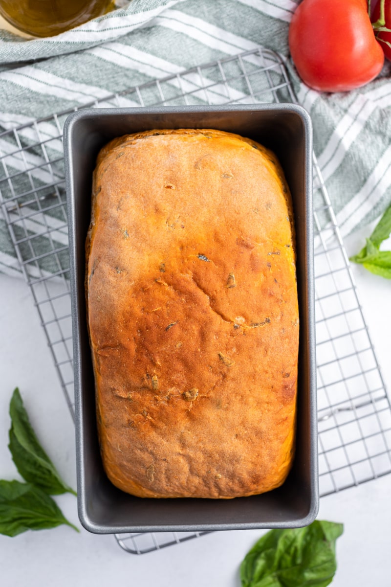 loaf of tomato basil bread in a pan