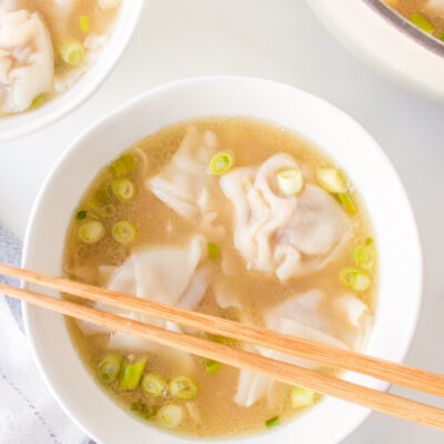 bowl of wonton soup with chopsticks