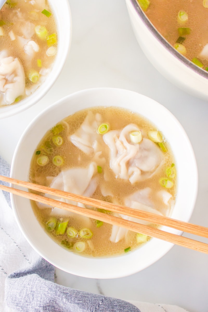 bowl of wonton soup with chopsticks