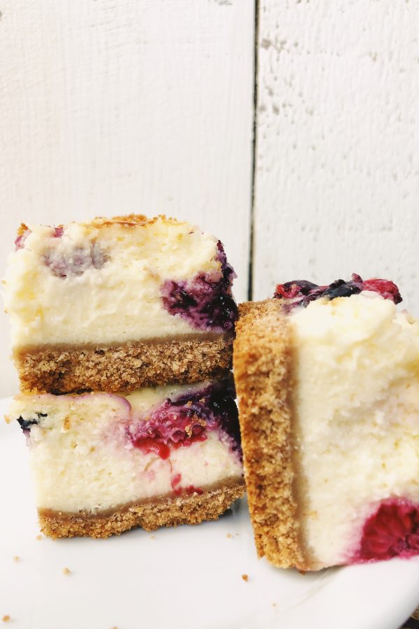 Red White and Blueberry Cheesecake Bars stacked on display