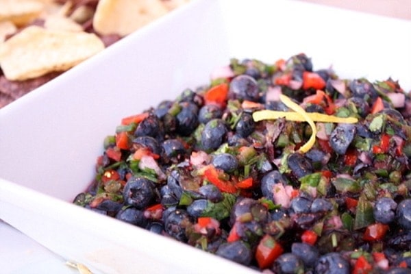 Fresh Blueberry Salsa displayed in a white bowl with chips on the side