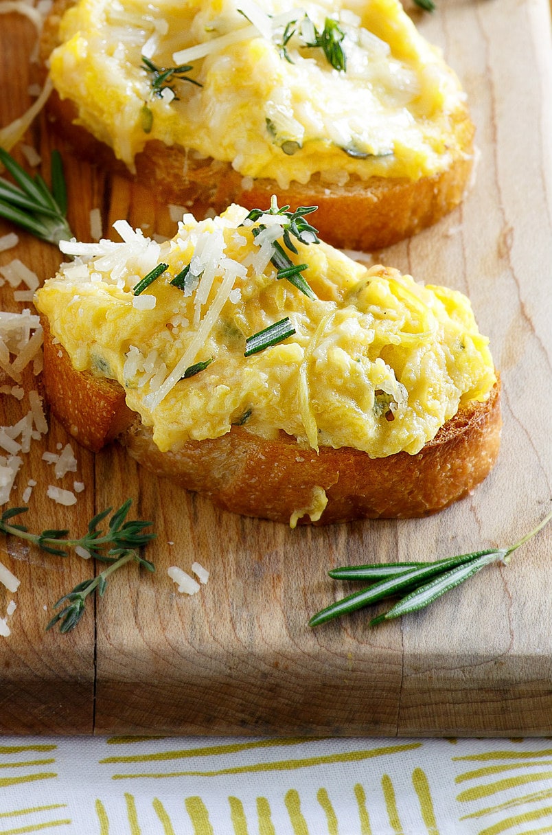 Butternut Squash Spread on baguette slices, garnished with cheese and herbs