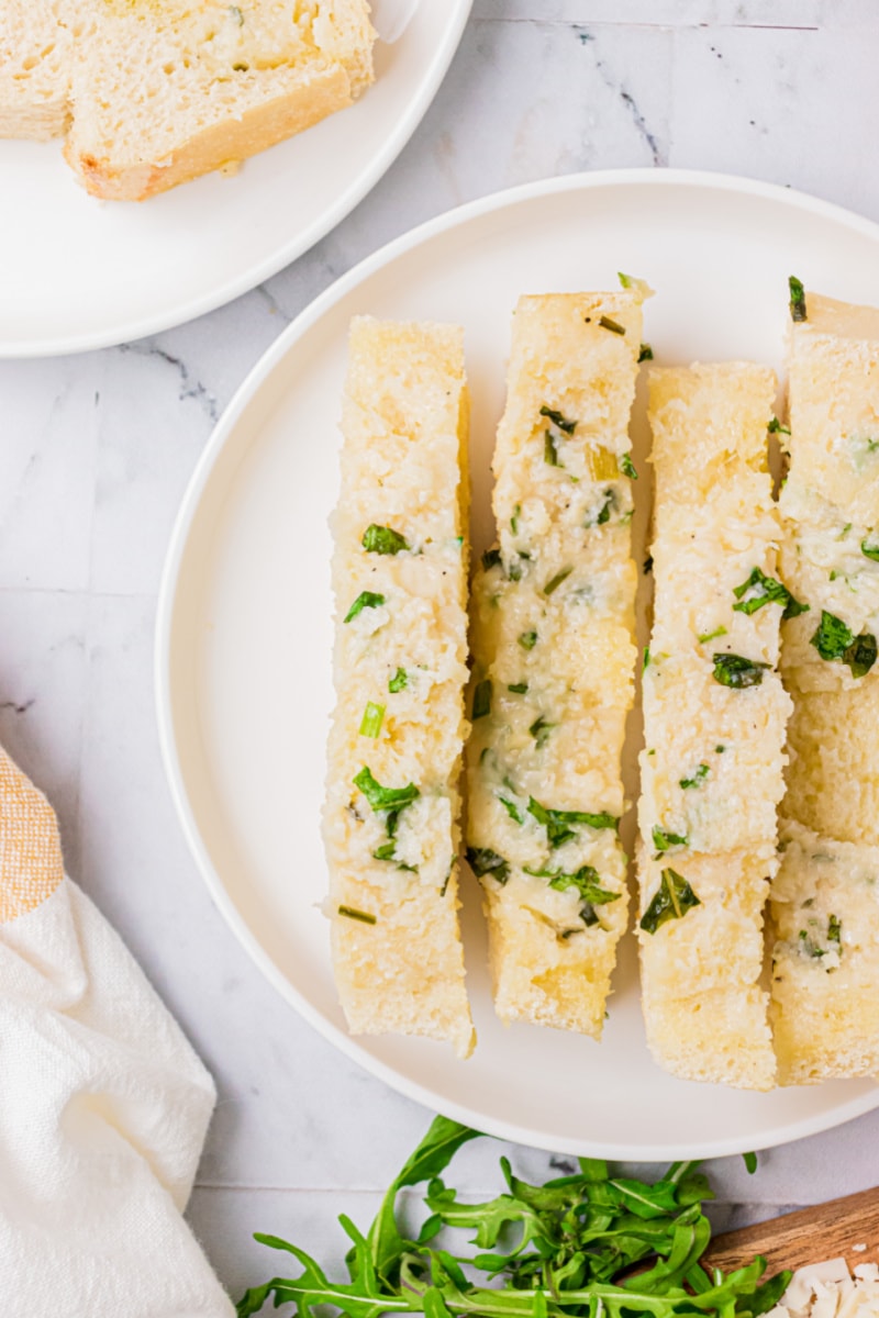 sliced cheese and herb bread on plate