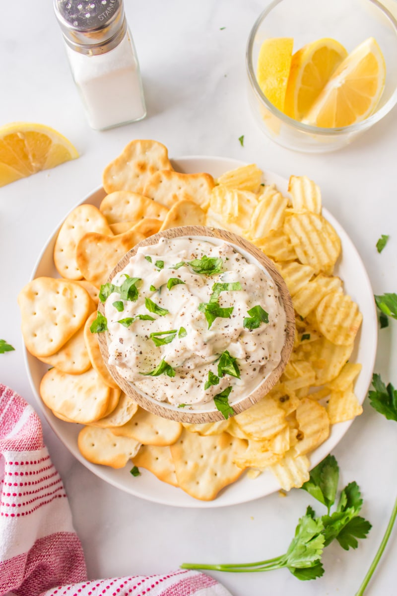 clam dip in bowl surrounded by chips