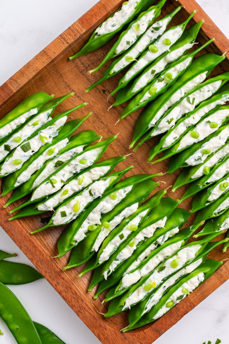 crab and cream cheese stuffed snow peas in a tray