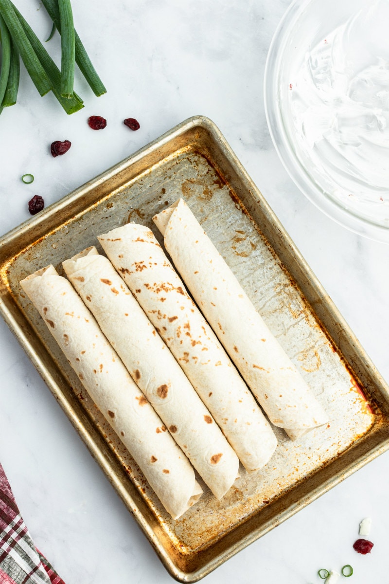 rolled up tortillas displayed for cranberry feta pinwheels