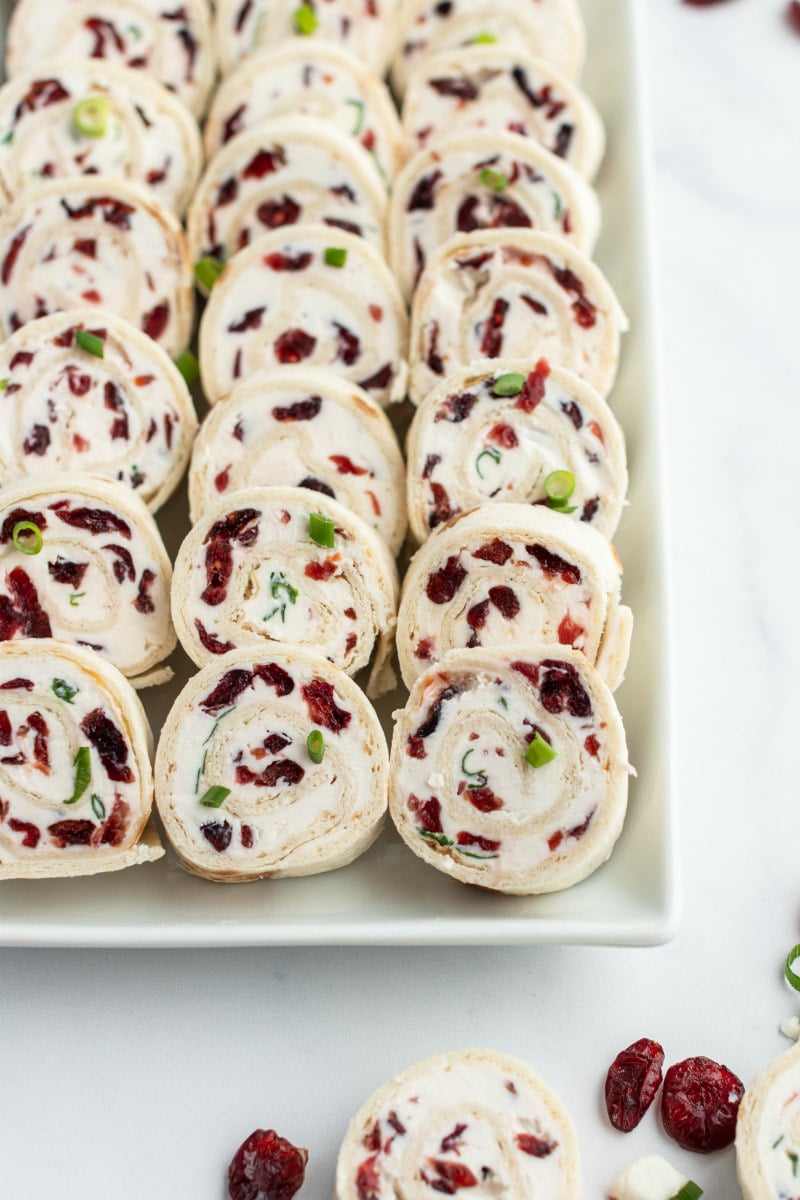 cranberry feta pinwheels displayed on white platter