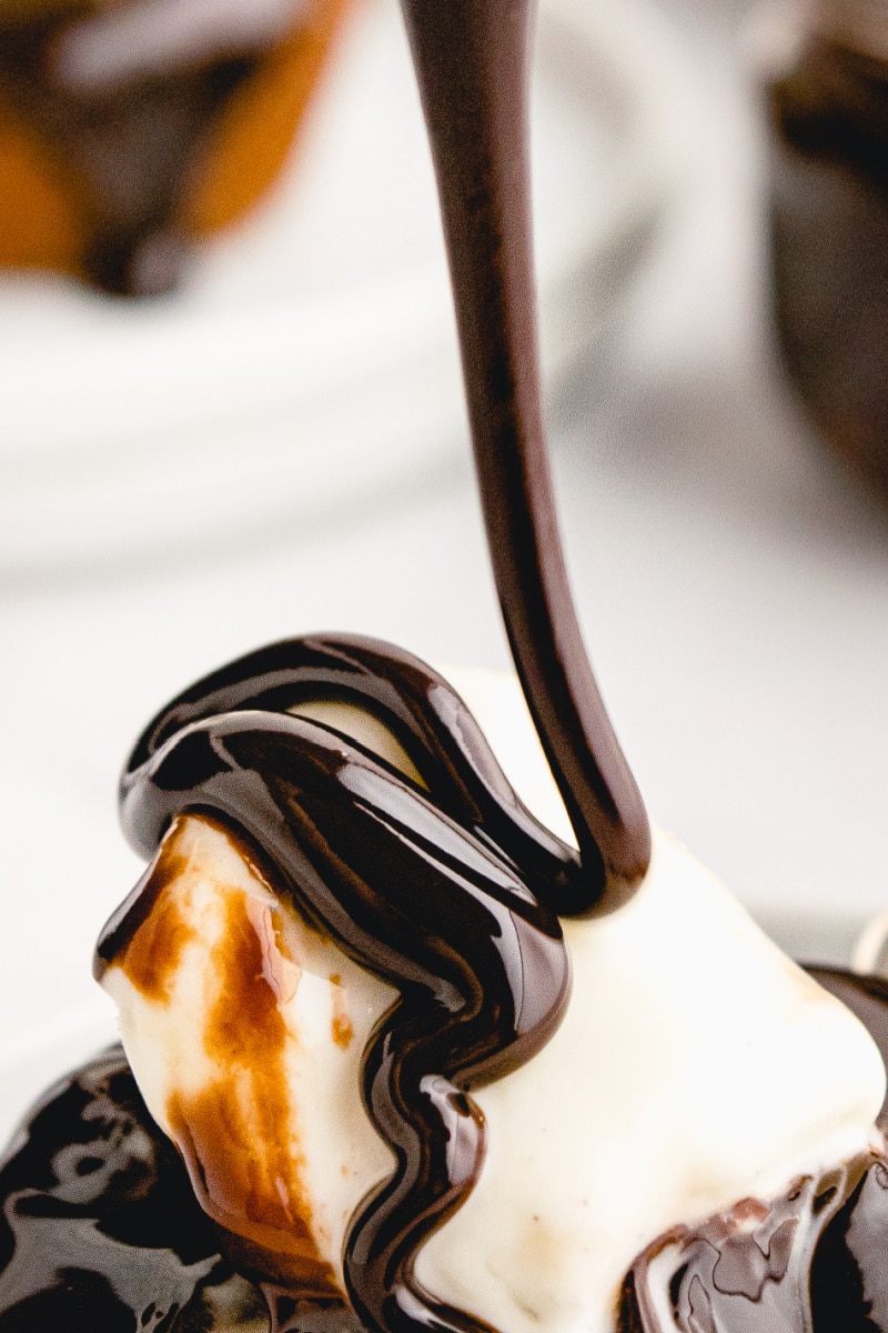 hot fudge being poured onto ice cream