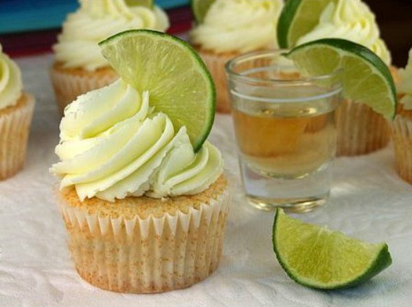 Margarita Cupcakes garnished with lime slices and tequila shots