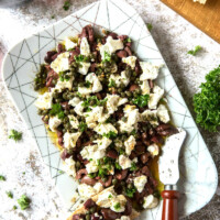 olive and goat cheese spread on a white platter