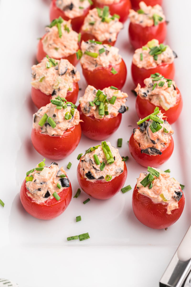 salmon stuffed cherry tomatoes on a white platter