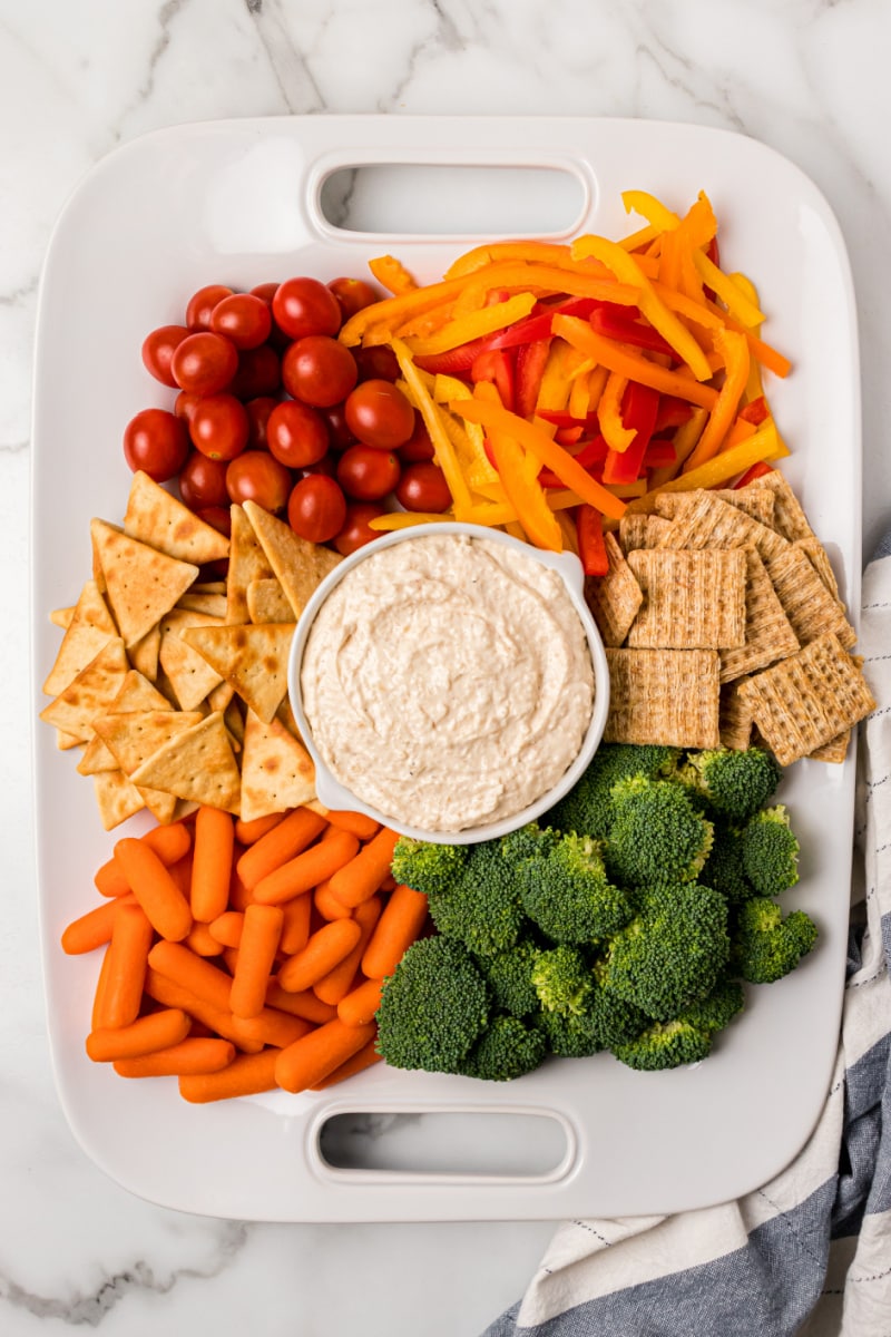 platter with onion spread and veggies and crackers