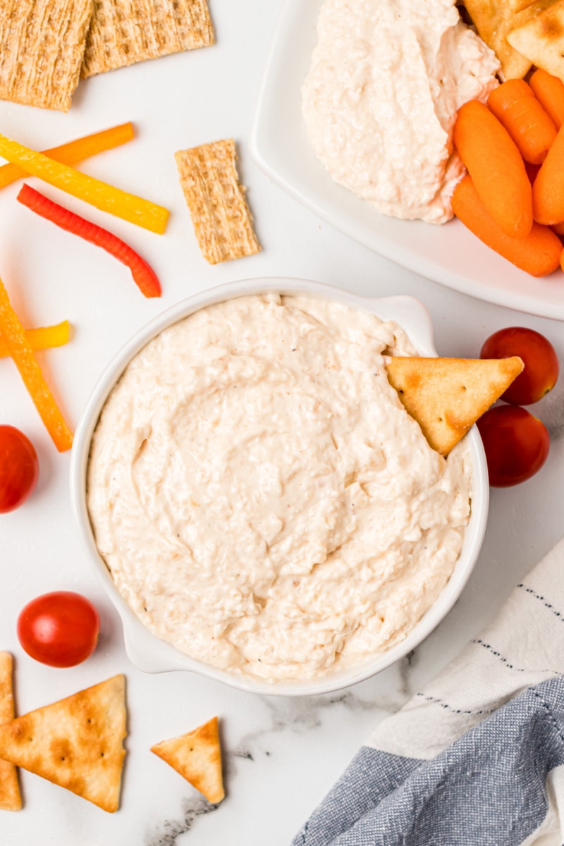 bowl of sweet caramelized onion spread with cracker stuck inside it