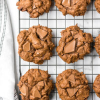 triple chocolate chunk cookies on a cooling rack