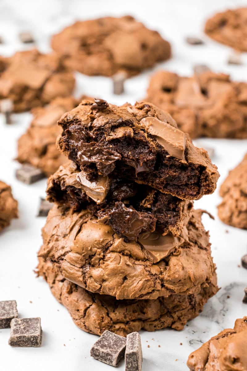 chocolate cookies stacked with one on top broken open to see the inside