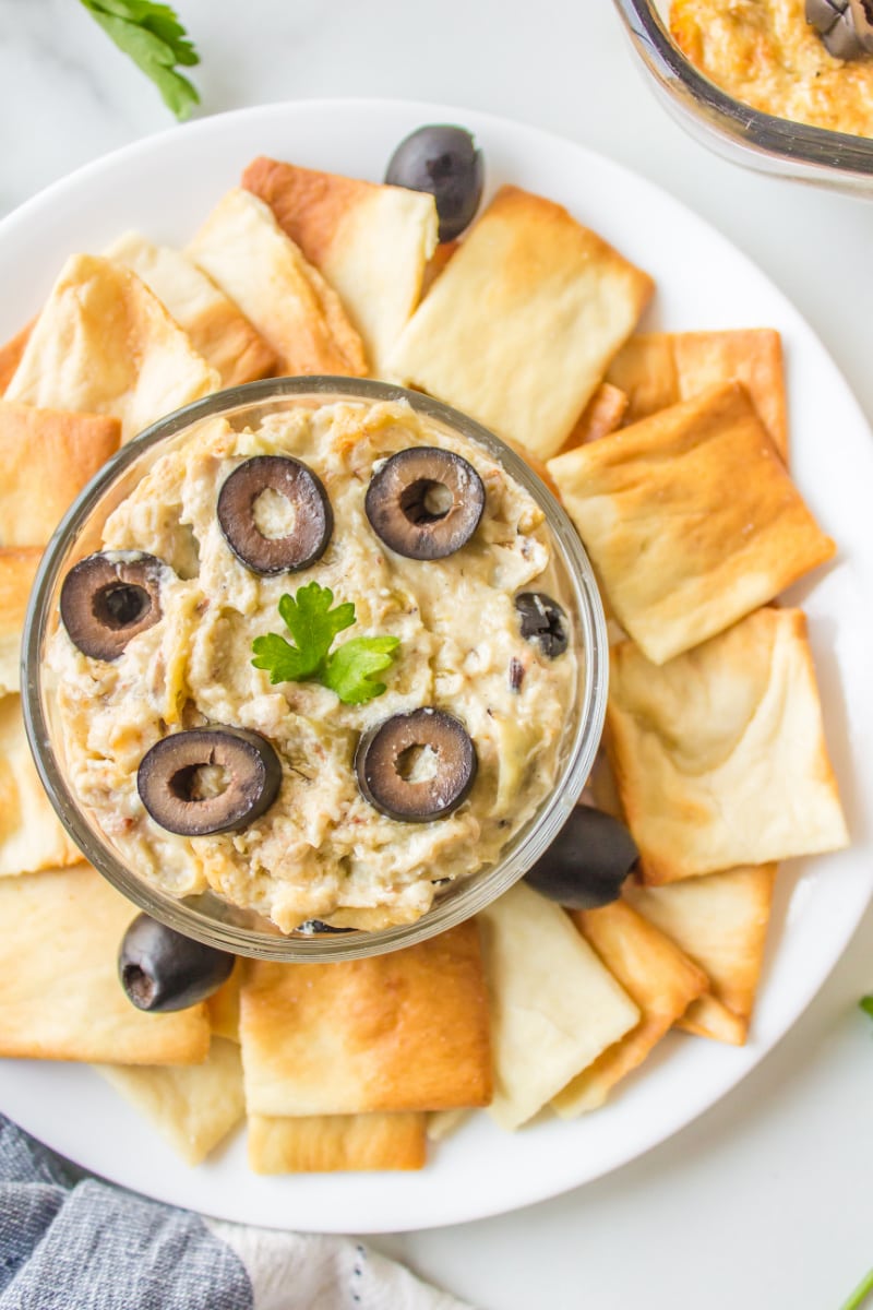 crab dip in a bowl with pita chips