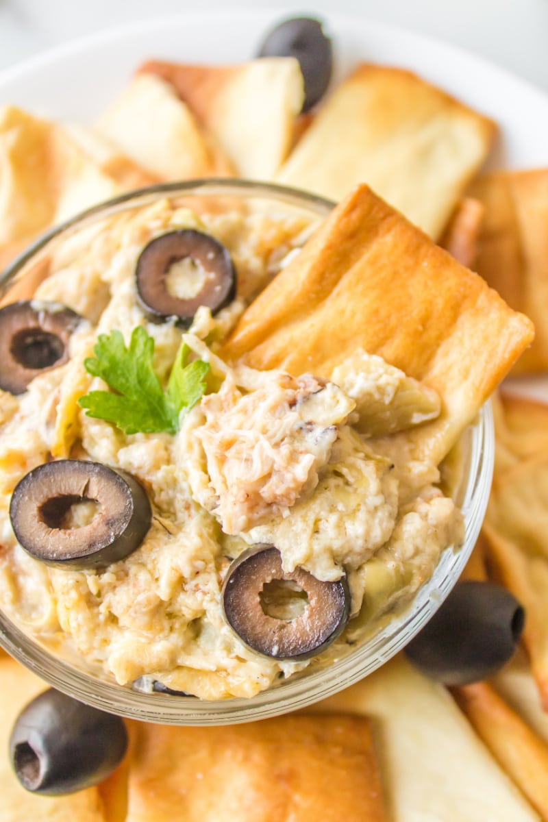 crab dip in a bowl with pita chips