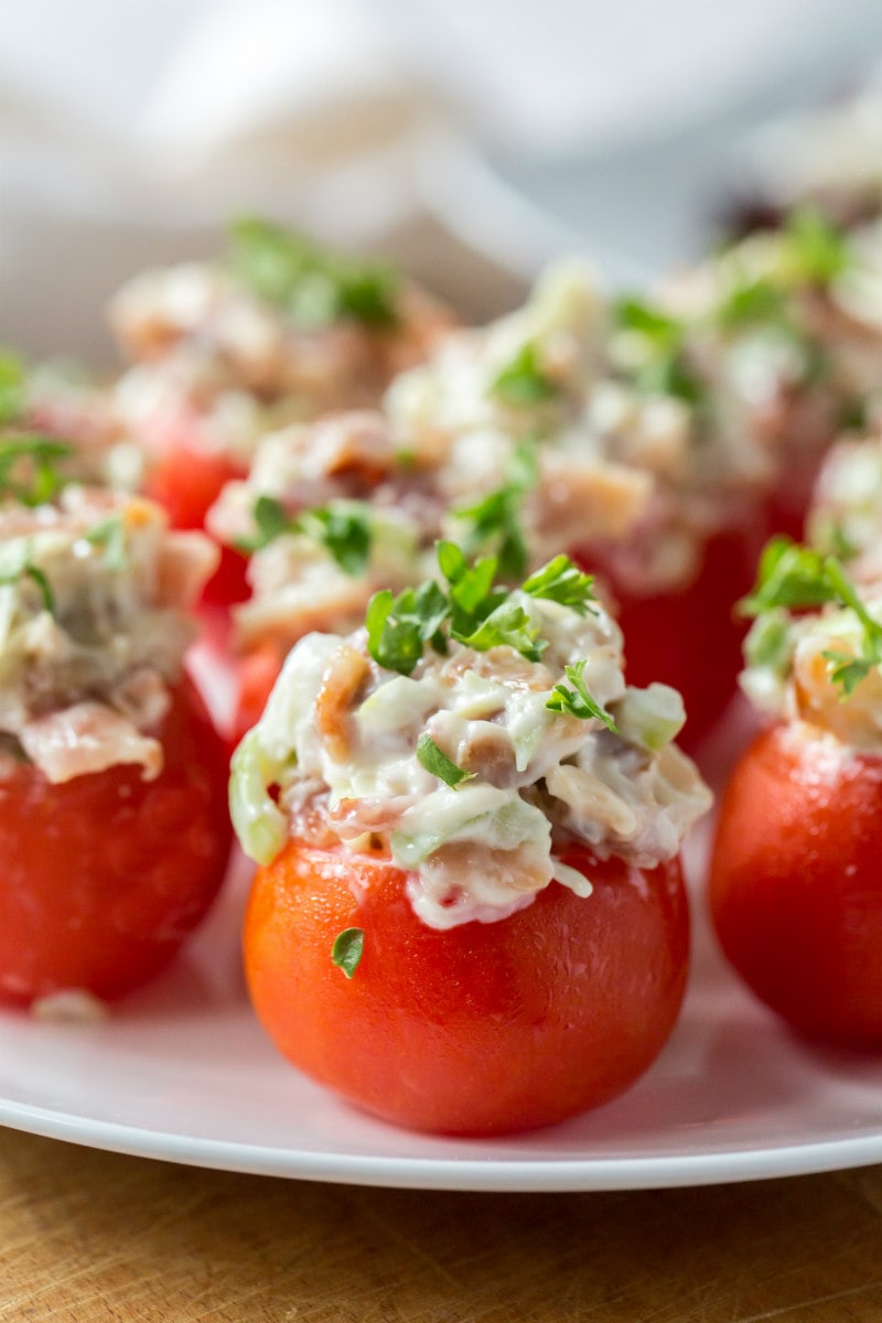 bacon stuffed cherry tomatoes on a white plate