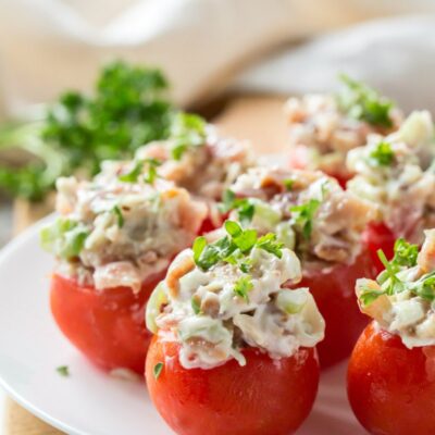 bacon stuffed cherry tomatoes on a white plate