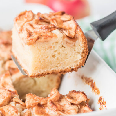 spatula taking out slice of apple coffee cake out of pan