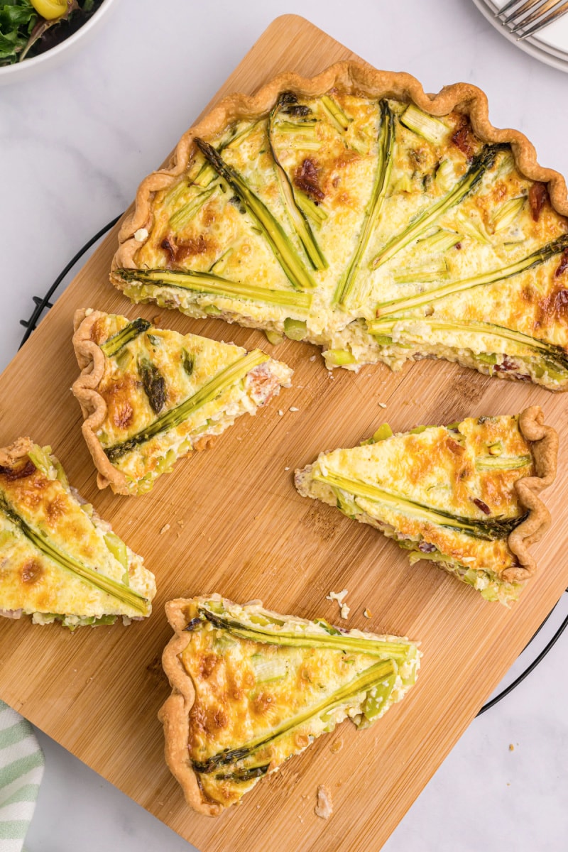 asparagus quiche on cutting board cut into slices