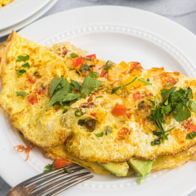 avocado manchego cheese omelette on plate with fork