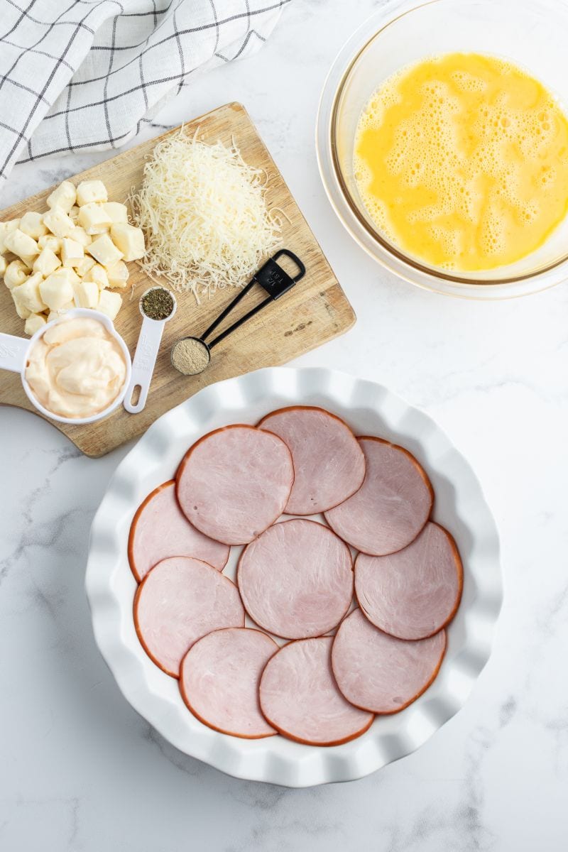 canadian bacon lined pie plate ready for making quiche