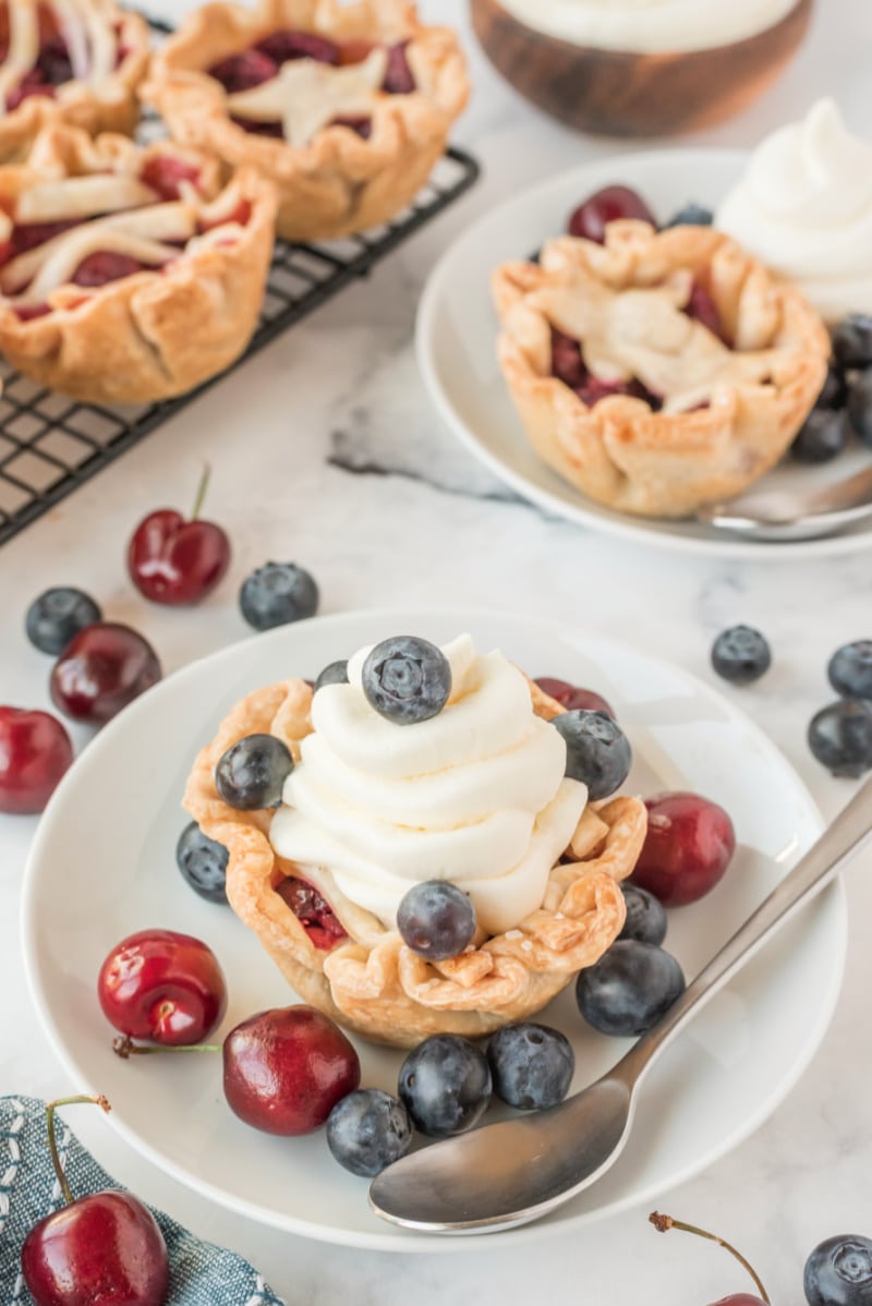 mini cherry pie cup with whipped cream and berries