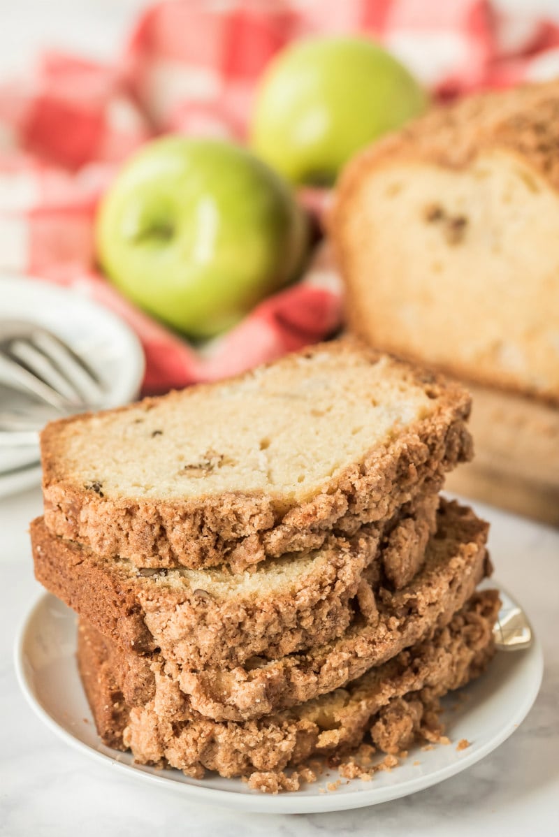 slices of apple bread stacked on a white plate