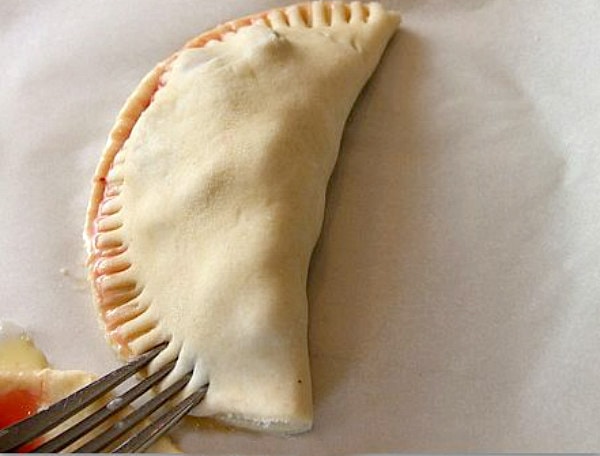 showing how to crimp the edges of turnovers using a fork