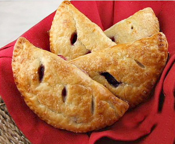 cherry turnovers in a red cloth lined basket