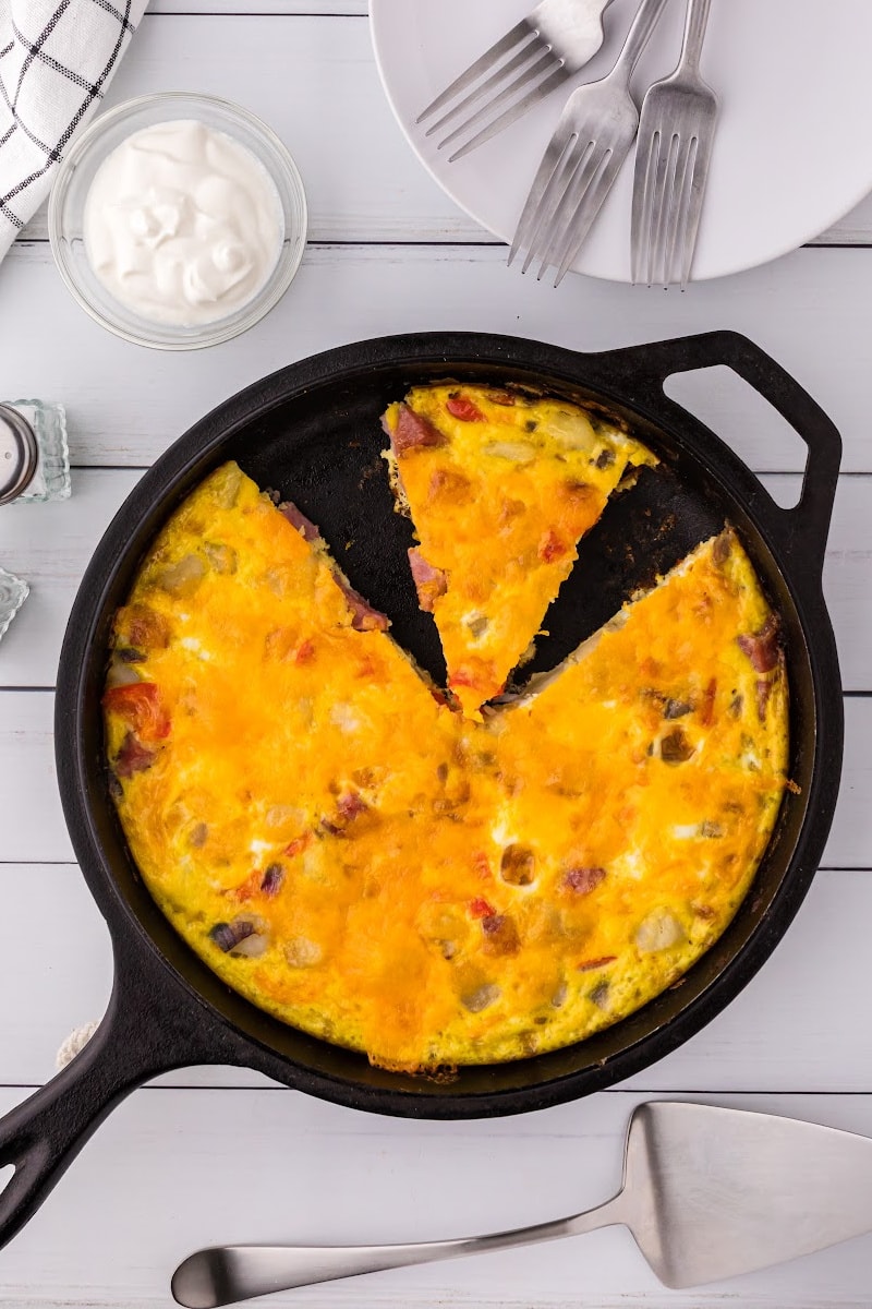 o'brien frittata in cast iron skillet with slice cut