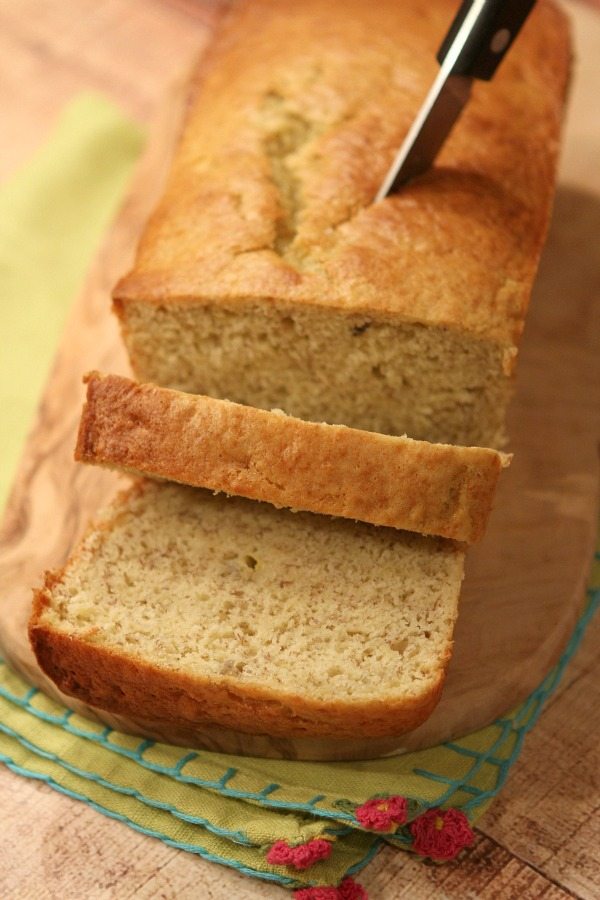 Low Fat Banana Bread loaf sliced open with knife stuck in top