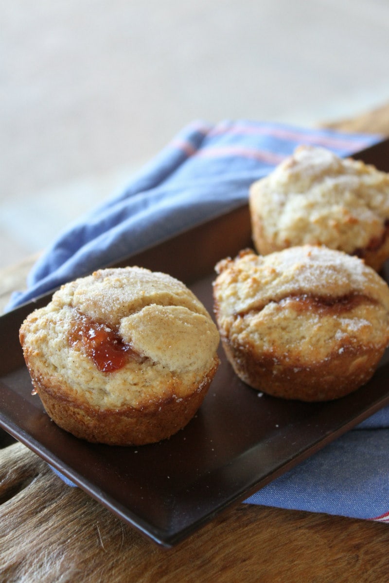 Low fat strawberry cinnamon muffins on a brown tray with a blue napkin