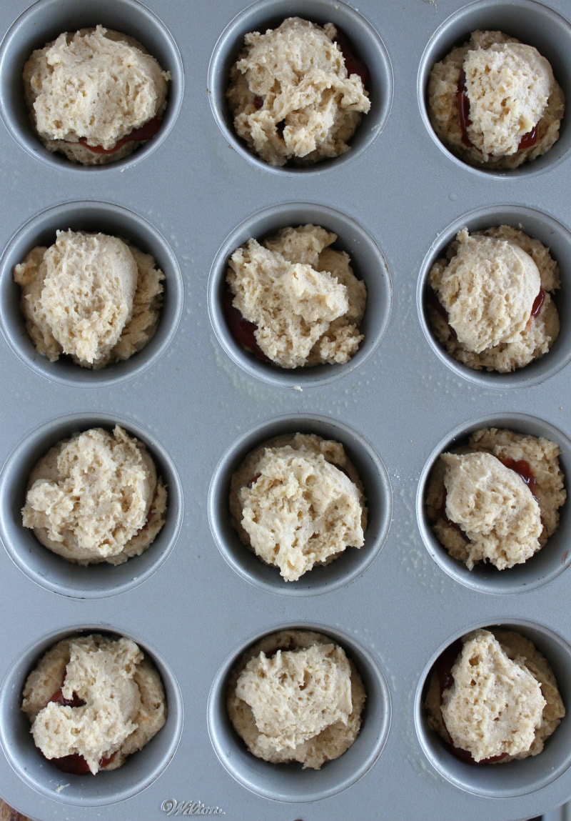 overhead shot of strawberry cinnamon muffin batter in a muffin tin