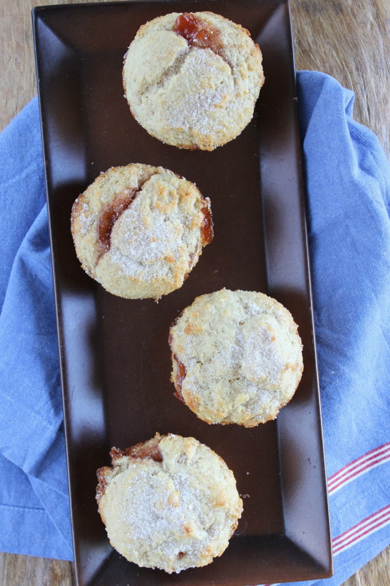 overhead show of low fat strawberry cinnamon muffins on a brown tray with a blue napkin