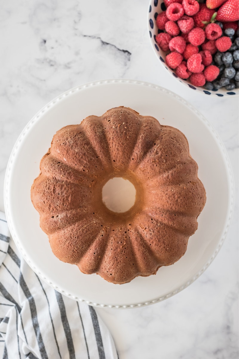 paula deen's cream cheese pound cake on a white serving platter