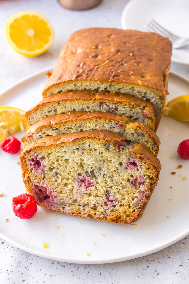 raspberry lemon loaf on plate cut into slices